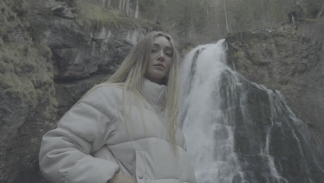 woman in front of a waterfall in a forest