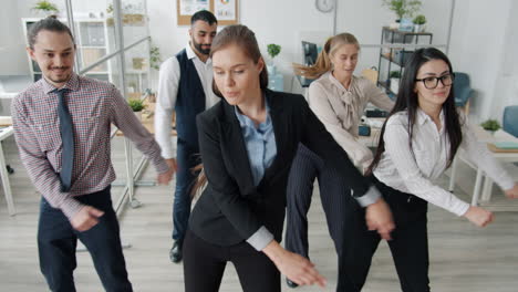 happy employees dancing in the office