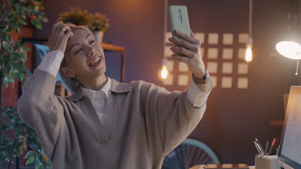 Woman taking selfie in an office