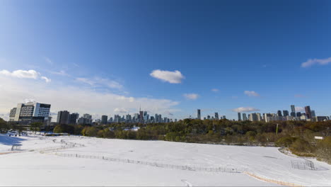 timelapse of the beautiful toronto skyline from riverdale park on a partly cloud, gorgeous snowy canada winter day