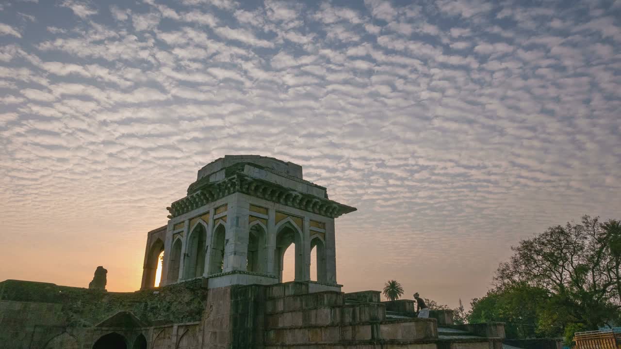 Time lapse Mandu India, afghan ruins of islam kingdom, mosque monument and muslim tomb. Colorful sky at sunrise.