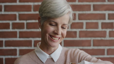 portrait beautiful middle aged woman using smart watching checking messages laughing enjoying mobile technology connection