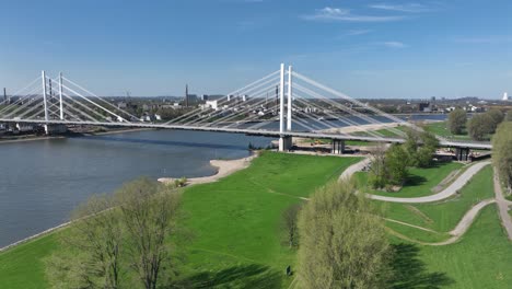 new construcuted hanging suspension bridge over the rhine river. traffic infrastructure. mobility, waterway and road. rhine bridge neuenkamp. aerial view.