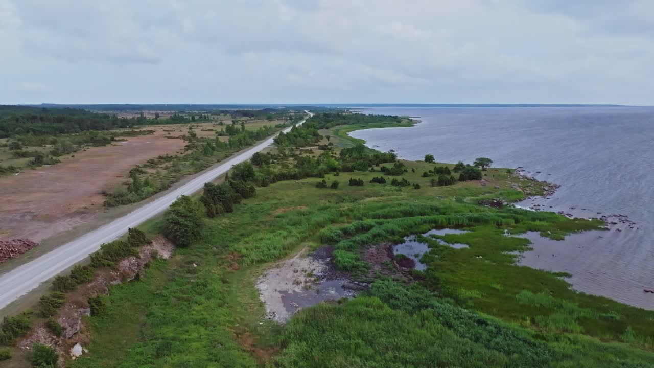 Flying besides a gravel road on the coastline of Saaremaa Estonia