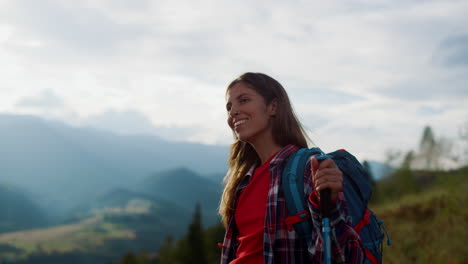 closeup positive tourist hike mountains peak landscape. cheerful woman trekking.
