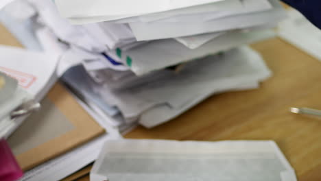 close up of a man opening debt letters