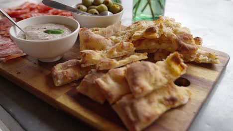 Freshly-made-pizza-appetiser-with-olives-on-a-plate-on-a-party