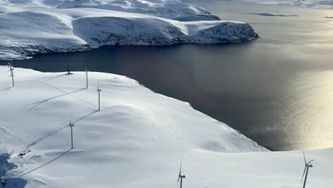 Havoysund-Wind-park-on-a-sunny-day,-Aerial-view-from-a-helicopter,-during-winter-in-Northern-Scandinavia