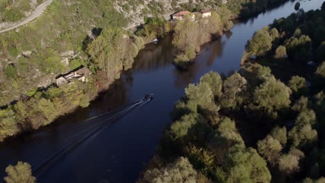 small motorboat cruising on lake skadar montenegro with tourists, aerial