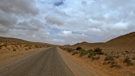 driving on tunisian desert road, driver point of view