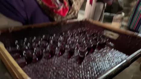 person serving wine in small glasses at a religious ceremony