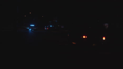 Police-scene,-street-taped-off-with-cars-with-blue-lights