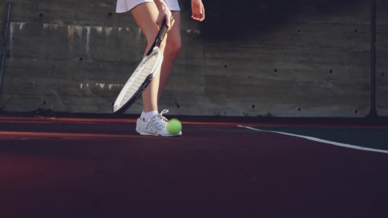 Woman playing tennis on a sunny day