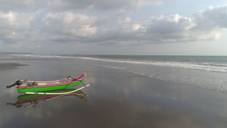 flying past an outrigger canoe on a beach