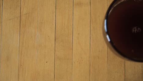 preparing coffee with sugar in a glass cup on wooden table