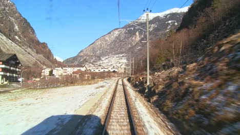 a pov shot from the front of a train moving through a mountainous region