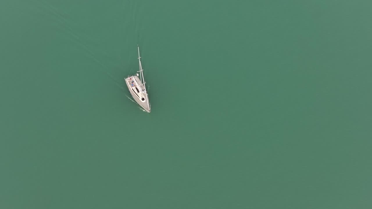 Aerial view of a sailboat on calm water