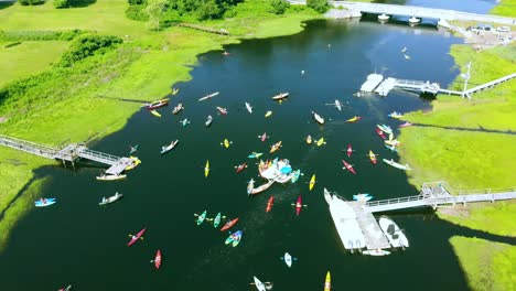 paddlers preparing for a kayak race - as seen via drone on a bright sunny day