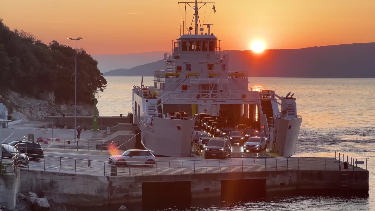 Concept of vehicle transportation, tourism, port and travel. Transporting cars to an island. Cargo ferry boat vessel ship. Ferry boat unloading cars at sunrise