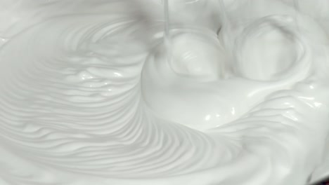 whipping cream with handheld mixer. - close up