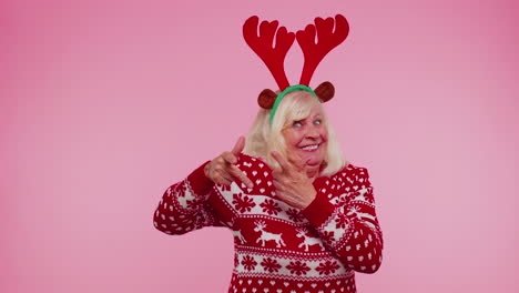 Crazy-senior-elderly-grandmother-woman-demonstrating-tongue-out,-fooling-around-making-silly-faces