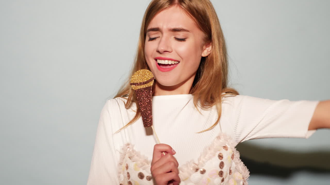 Woman Holding a Glitter Microphone