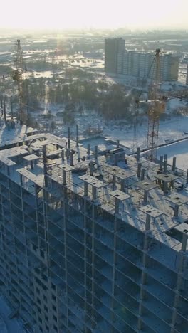 construction site of a multi-story apartment building in winter