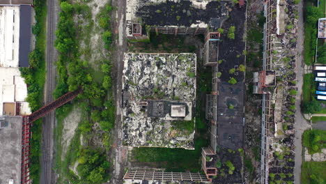 Aerial-view-above-abandoned-buildings-in-cloudy-USA---top-down,-drone-shot