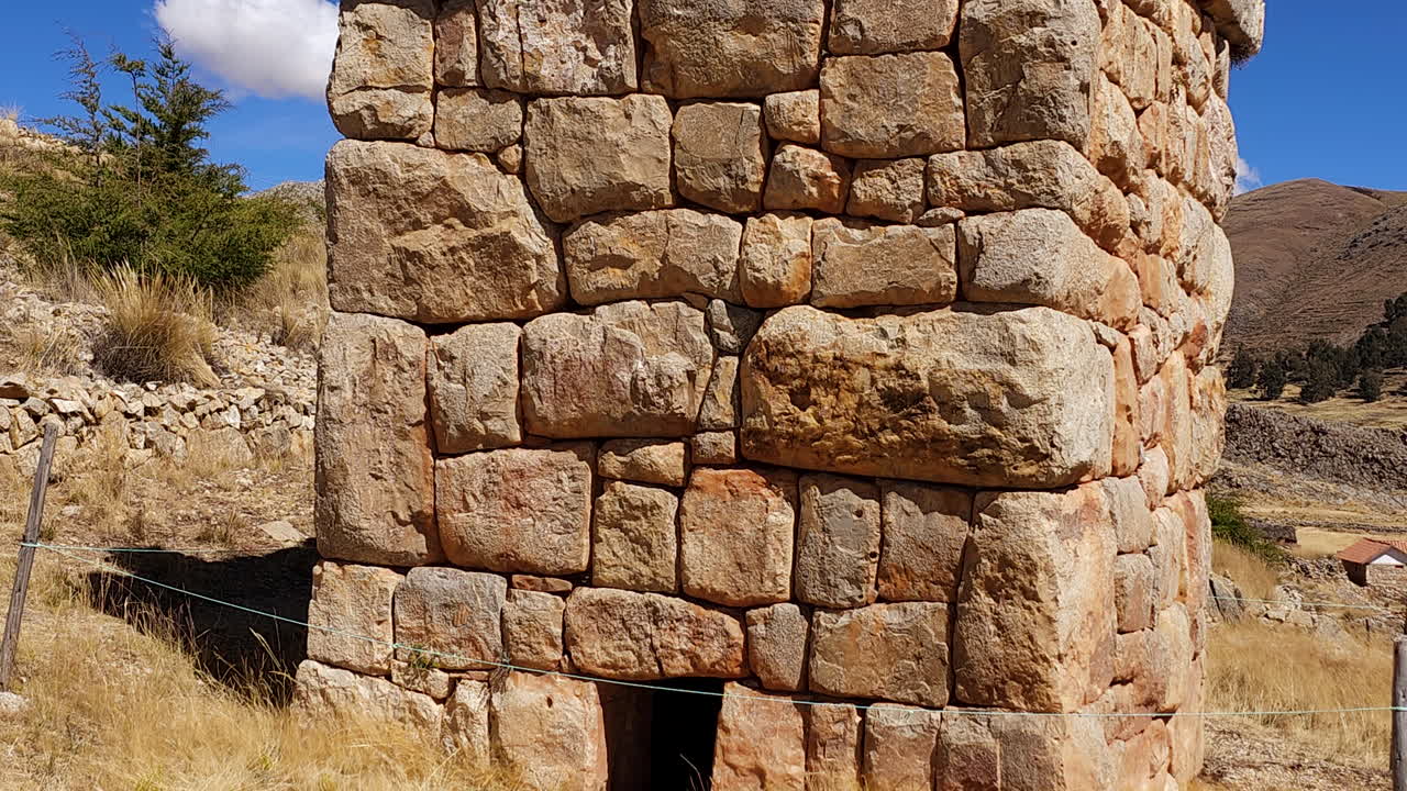 A stunning panoramic view of the ancient stone funerary monuments of Chullpas de Molloco near Acora, Peru, highlighting their historical significance in the Andean landscape