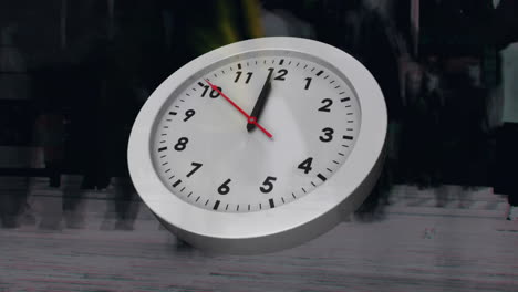 people walking fast with clock in the foreground