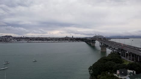 aerial view of the auckland harbour bridge in auckland, new zealand with car traffic and boats 4k