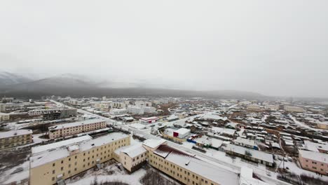 aerial view of a snowy town in the mountains