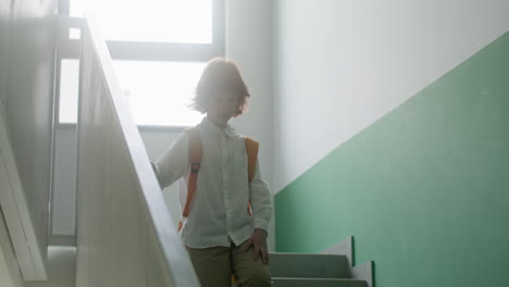 schoolboy walking down stairs.