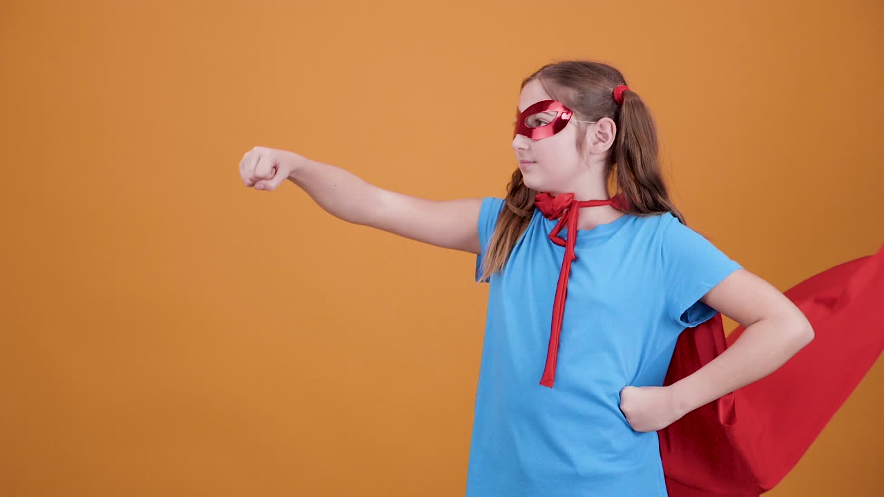 Girl in Superhero Costume with Cape and Mask