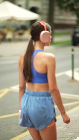 woman walking outdoors in sporty outfit