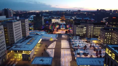 4k twilight aerial fly over led runway winter post modern provincial legislature buildings centered with a beaux arts dome rooftop government structure of capital city of edmonton alberta canada 3-4
