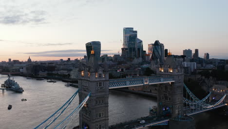 Closeup-of-Tower-Bridge.-Aerial-view-of-old-bridge-across-River-Thames-in-evening.-Modern-skyscrapers-in-background.-London,-UK