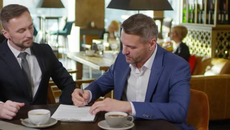 businessmen signing contract