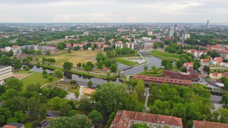 Klaipeda-city-buildings-and-green-environment,-aerial-ascend-view