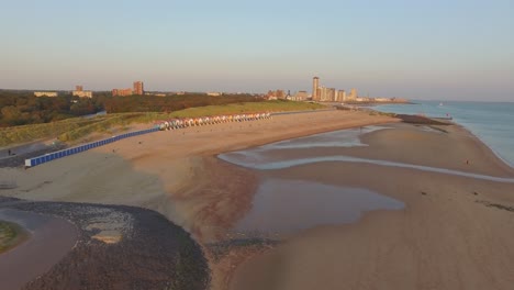 aerial: the boulevard, beach and city of vlissingen during sunset