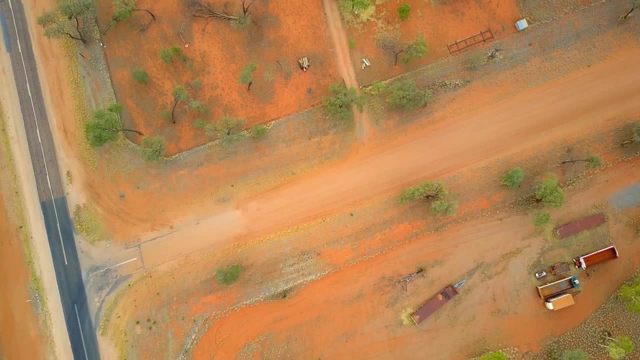 The Central Australian Outback. Top down shot, over roads, local flora and settlements. Filmed on a DJI Mavic Pro on a Camel Farm near Alice Springs.