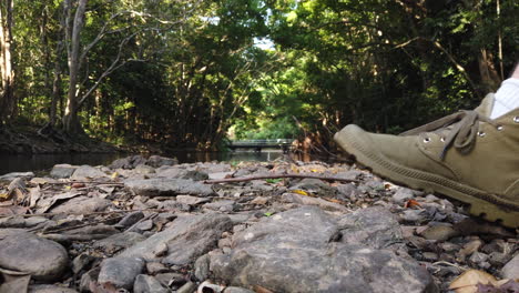 close-up-of-foot-walking-on-rocks