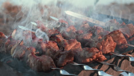 closeup smoked bbq grilling on brazier. barbecue meat roasting on charcoal