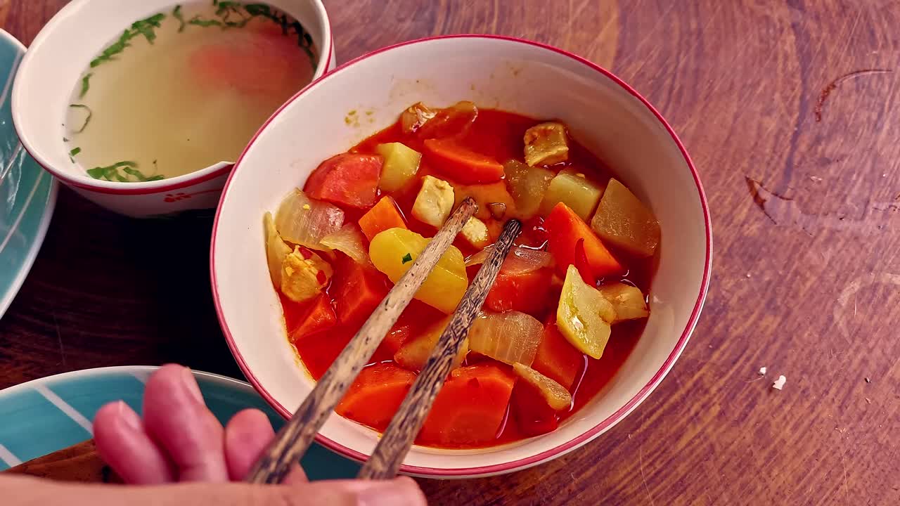 Overhead handheld pov candid video of eating authentic traditional local khmer breakfast food of Trei boeng kanh chhet or spicy fried fish and Bai sach chrouk or pork with steamed rice