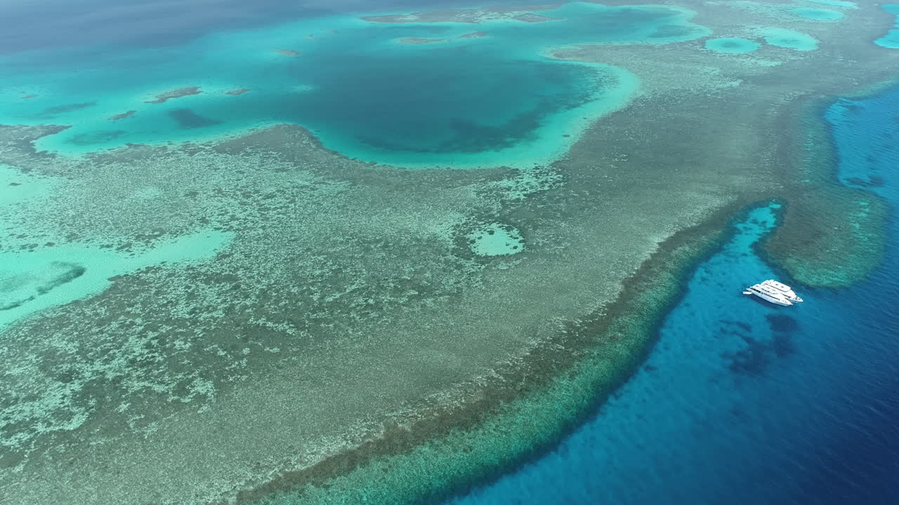 Aerial view of a coral reef with a boat