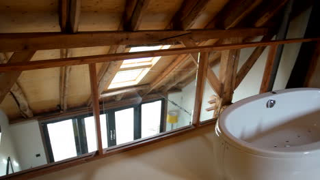 white bathtub at attic bedroom with skylight roofing