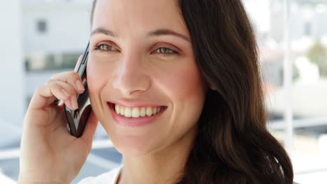 cheerful businesswoman being on the phone
