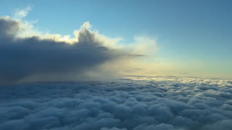 aerial pov flying through an ethereal cloudscape at sunrise, taken from inside a jet cockpit with the sunlight illuminating the horizon