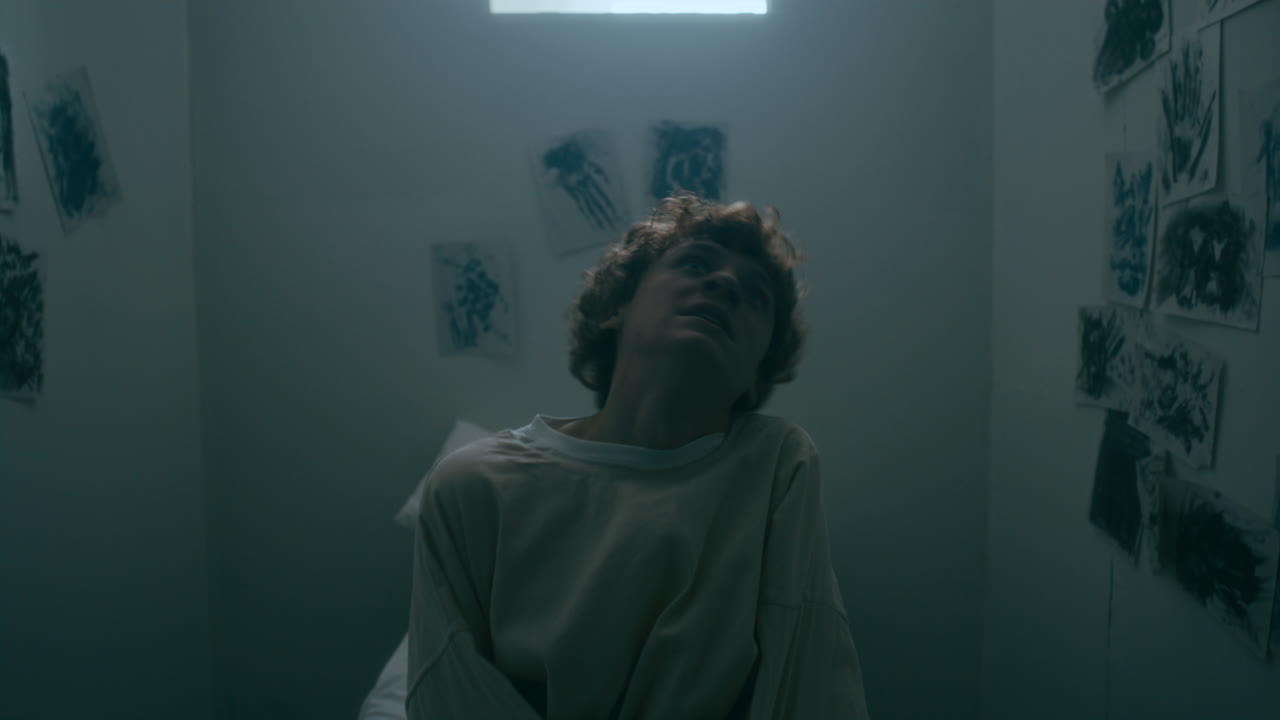 Terrified Patient in Straitjacket Screaming in Asylum Room