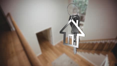 animation of silver key and house key ring over blurred house interior